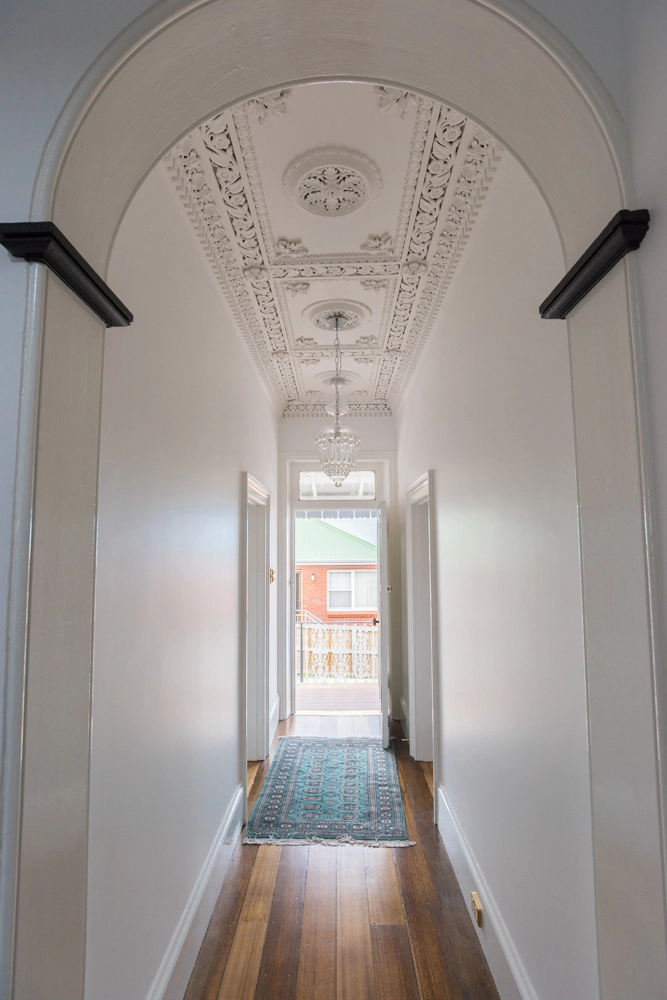 Long hallway painted white in heritage house Hobart