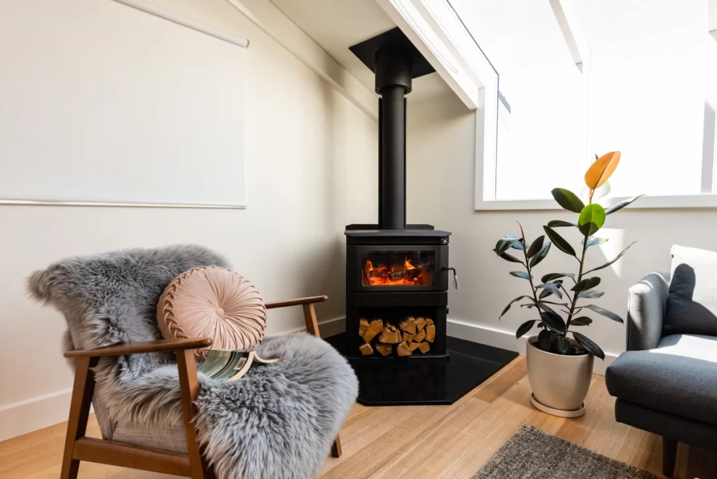 Scandi chair with fireplace in background in a freshly interior painted walls